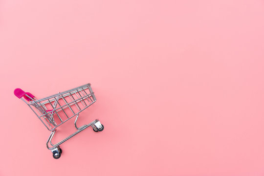 Empty shopping cart on pink background. Shopping, shopping online concept.,copy space, top view