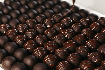 Round chocolates candy. Dark background, luxury dessert, dark chocolate, handmade.