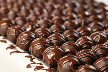 Round chocolates candy. Dark background, luxury dessert, dark chocolate, handmade.