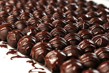 Round chocolates candy. Dark background, luxury dessert, dark chocolate, handmade.