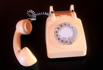 Vintage telephone on black desk