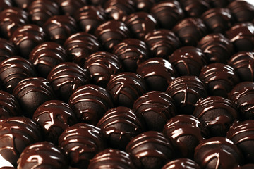 Round chocolates candy. Dark background, luxury dessert, dark chocolate, handmade.