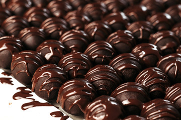 Round chocolates candy. Dark background, luxury dessert, dark chocolate, handmade.
