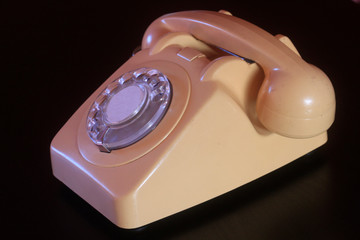 Vintage telephone on black desk