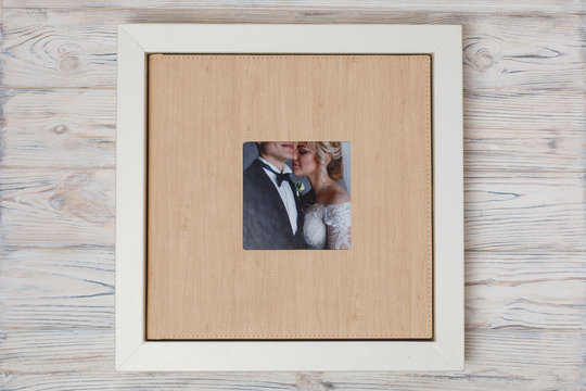 stylish  box for photobooks.. cardboard box for a family photo album .  Box with  wedding photo album with copy space for text. leather wedding photo book in the box .