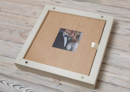 stylish  box for photobooks.. cardboard box for a family photo album .  Box with  wedding photo album with copy space for text. leather wedding photo book in the box .
