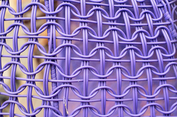 The texture of a wicker chair made of plastic. Processing.Purple