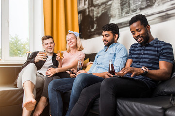 Cheerful multi-ethnic friends sitting on a sofa