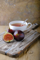 Fototapeta na wymiar Fresh ripe figs and cut in half on a wooden table.