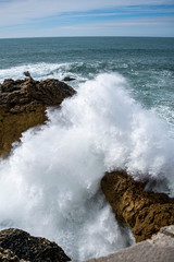 Waves crashing on the rocks in Nazare, Portugal