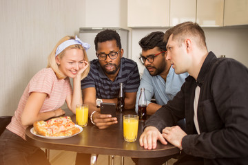 Young friends eating pizza at home