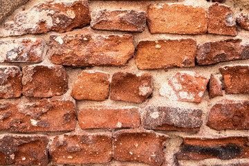 Old irregular brick wall - background or texture