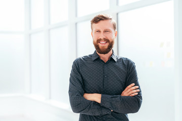 Fototapeta premium successful businessman standing near the office window