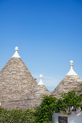 Fototapeta na wymiar Traditional Trulli houses, stone roof. Alberobello, Puglia, Italy