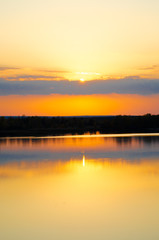 orange sunset on a blue lake