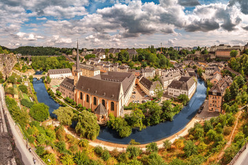 Panoramic view of the Church of St Jean du Grund and the old town in the valley of the river Alzette. Travel destinations in tiny country of Luxembourg