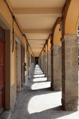 Long colonnafe corridor with columns and . Perspective. . Color image.