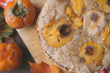 1 autumn homemade cake with persimmon top view close up