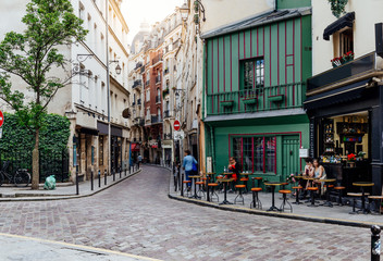 Cozy street with tables of cafe in Paris, France - obrazy, fototapety, plakaty