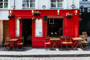 Cozy street with tables of cafe in quarter Montmartre in Paris, France