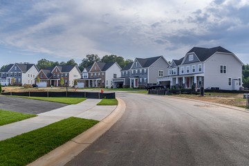 Typical American colonial contemporary traditional single family estate home street in a new...