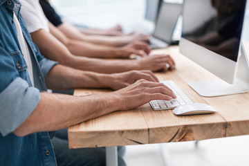close up. a group of employees work on their computers