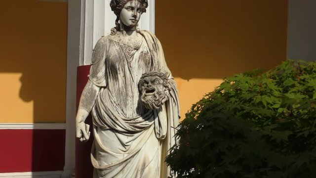 The statue of the Muse of Melpomene with a tragic mask in his hands. Corfu island, Greece.