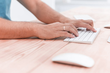 close up. young man typing on computer keyboard