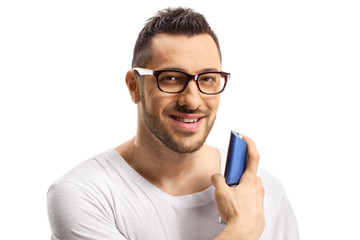 Close up of a man spraying a perfume