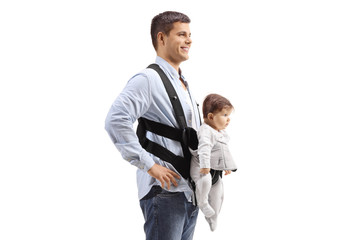 Father with a baby in a carrier standing and smiling