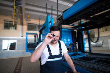 Shot of professional experienced serviceman mechanic choosing appropriate tools for vehicle service.
