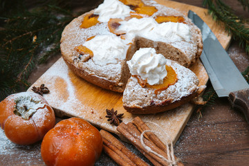 winter cake with persimmon, cinnamon sticks, star anise, spruce branches