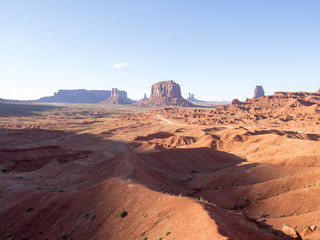 Panoramic view of Monument Valley, Utah, USA on a hot sunny day with the view of  West Mitten Butte, East Mitten Butte, and Merrick Butte