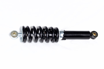 a brand new clean black and silver motorcycle shock absorber over white, this shock is also used on ATVs.