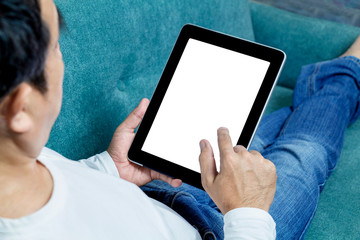Man hands holding tablet lying on sofa ordering online food on touch screen. Delivery service food shopping concept for order online. Business and technology with lifestyle in city.
