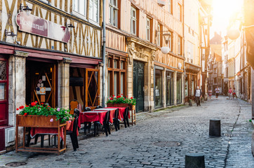 Cozy street with timber framing houses and tables of restaurant in Rouen, Normandy, France - obrazy, fototapety, plakaty
