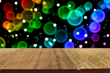Festive decorative background. Halloween decor concept. Wooden table and holiday lights. Copy space.