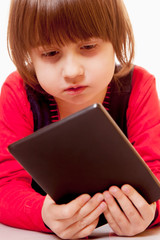 Little cute brunette child girl with tablet