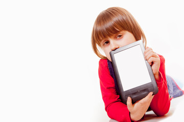 Fototapeta premium Little cute brunette child girl showing blank tablet monitor with copyspace area