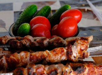 freshly grilled pork skewers and vegetables