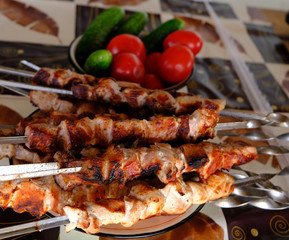 freshly grilled pork skewers and vegetables