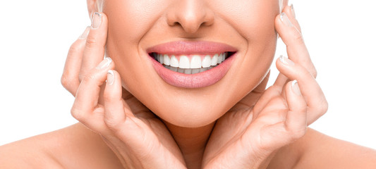 Dental health concept: woman touching face and smiling close up. Isolated on white.