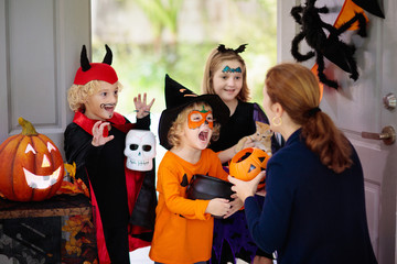 Kids trick or treat. Halloween. Child at door.