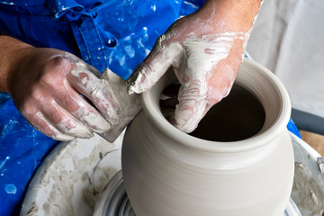Master class on modeling of clay on a potter's wheel In the pottery workshop