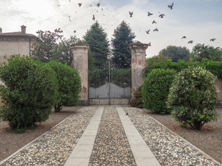 elegant cobblestone entrance of a Lombardy countryside villa, Italy