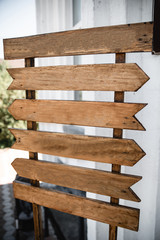 Wedding wood decoration. Copyspace on wooden board. Wooden table decorated by flowers and greenery and lounge zone. Wedding photo zone. Party zone rustic style.