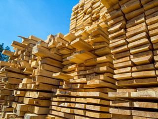 Wooden boards stacked in a rack in an open-air warehouse
