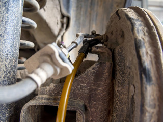 Hose connected to brake fitting for fluid change