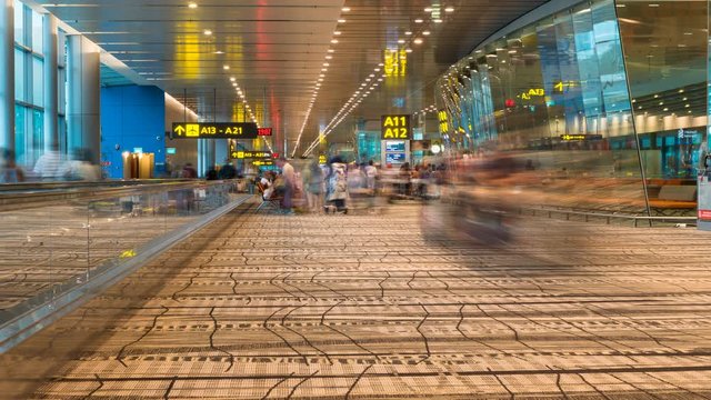 Changi airport, Singapore City, Singapore - February 12, 2017: Time lapse footage of passengers, crowd and people in Changi international airport in Singapore, the largest airport in Singapore