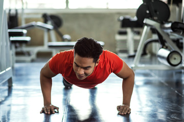 Obraz na płótnie Canvas FItness man push up in gym